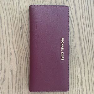 Michael Kors Plum Slim Wallet with compartments.